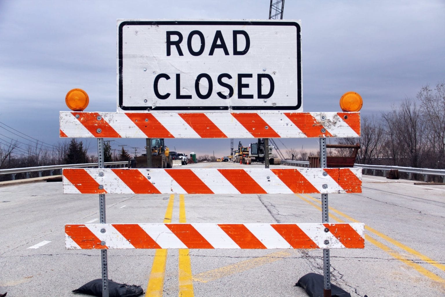 a caution sign in the middle of the road