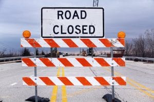 a caution sign in the middle of the road